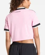 Back lifestyle view of a model wearing the Adidas Juventus 26/27 Womens Away Cropped Soccer Shirt featuring true pink fabric, Juventus branding, and cropped athletic fit.