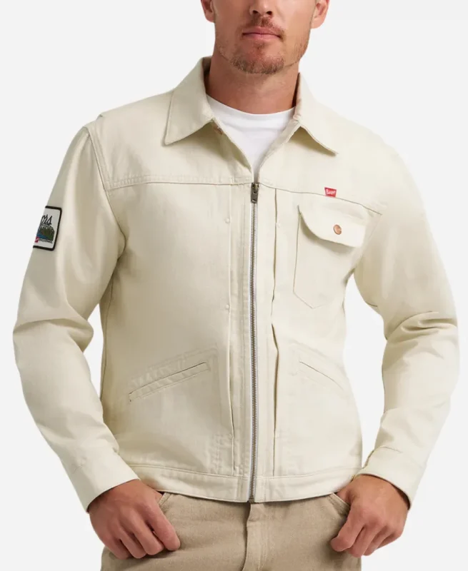 Front view of male model wearing white cotton Coors Banquet x Wrangler Pinnacle trucker jacket with zip closure.