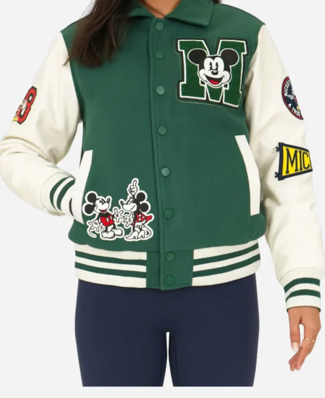 Front view of Disney Adult Unisex varsity jacket in green featuring Mickey Mouse patches, snap button closure, rib knitted hem and sleeves.