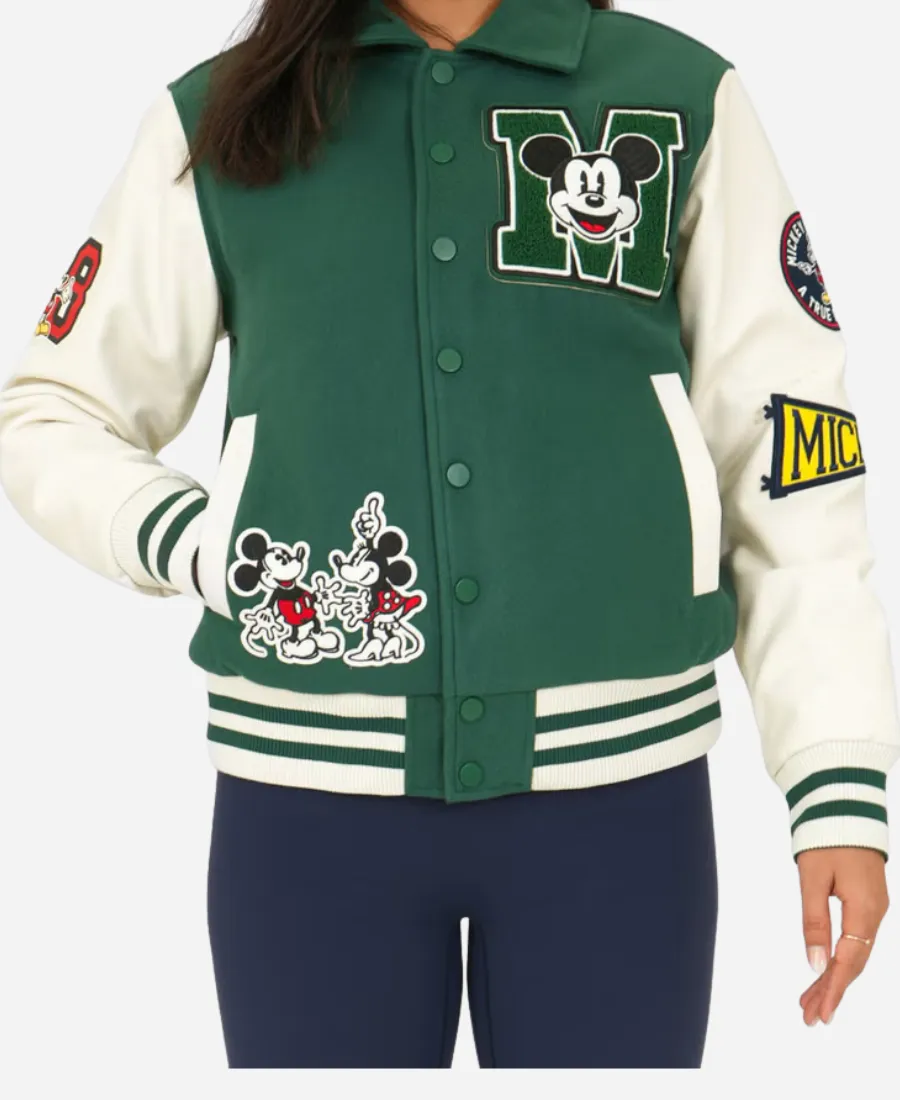 Disney Adult Green Varsity Jacket Front View with Mickey Mouse Patches Front view of Disney Adult Unisex varsity jacket in green featuring Mickey Mouse patches, snap button closure, rib knitted hem and sleeves.