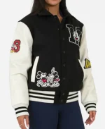 Side profile of black Disney varsity jacket featuring Mickey Mouse patches, shirt style collar and snap button front.