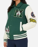 Side angle of green Disney varsity jacket with Mickey Mouse embroidered patches, white sleeves and classic varsity styling.