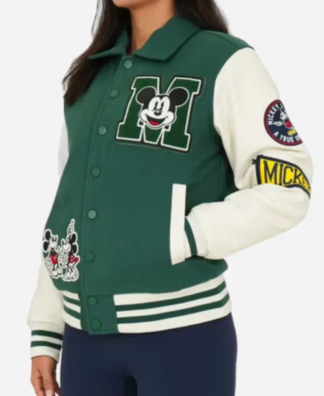 Side angle of green Disney varsity jacket with Mickey Mouse embroidered patches, white sleeves and classic varsity styling.