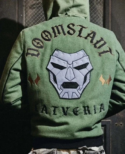 Lifestyle back view of a person wearing the Marvel Doctor Doom Army Hooded Varsity Jacket displaying the embroidered Doctor Doom artwork and Latveria graphics.