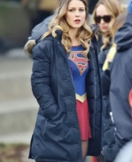 Melissa Benoist in fur trimmed hooded blue puffer coat on Supergirl set